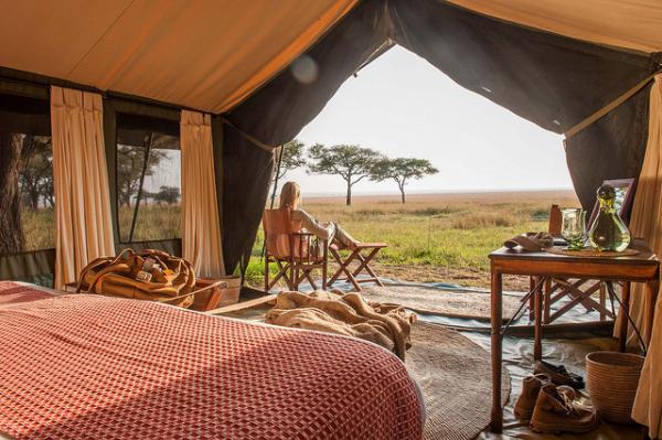 View from a luxury safari tent bedroom looking out over the Serengeti plains.